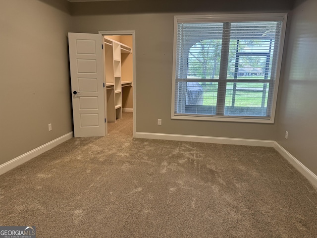 293 Laurel Landing Blvd, Kingsland, GA 31548 - unfurnished bedroom with carpet flooring, a walk in closet, baseboards, and a closet