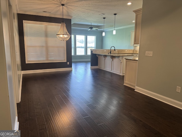 293 Laurel Landing Blvd, Kingsland, GA 31548 - kitchen with baseboards, a breakfast bar area, crown molding, a sink, and a peninsula
