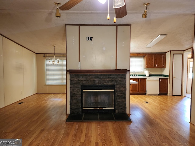 715 Bailey Jester Rd, Griffin, GA 30224 - unfurnished living room featuring light wood-type flooring, a sink, a chandelier, a fireplace, and crown molding