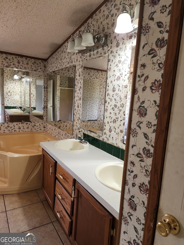 715 Bailey Jester Rd, Griffin, GA 30224 - bathroom with a textured ceiling, wallpapered walls, tile patterned flooring, double vanity, and a bath