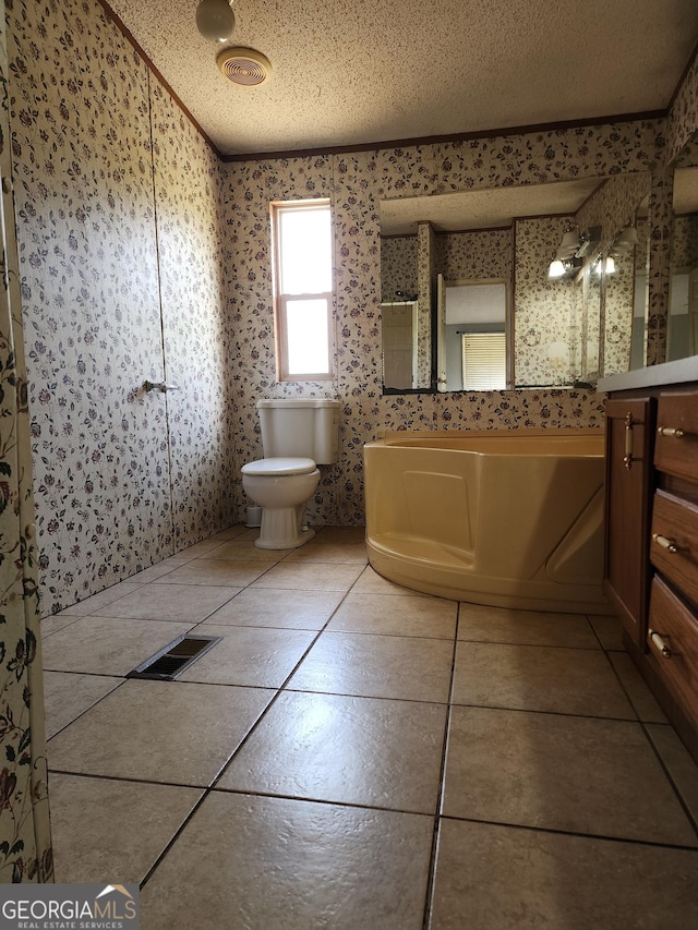 715 Bailey Jester Rd, Griffin, GA 30224 - full bath featuring wallpapered walls, a textured ceiling, toilet, vanity, and tile patterned flooring