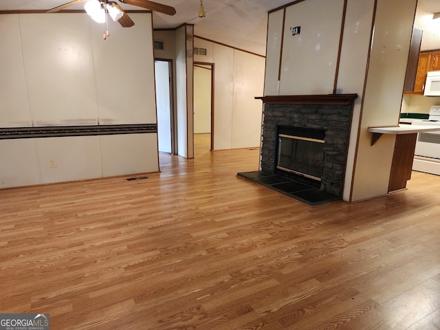 715 Bailey Jester Rd, Griffin, GA 30224 - unfurnished living room with light wood-style floors, ceiling fan, a fireplace, and crown molding