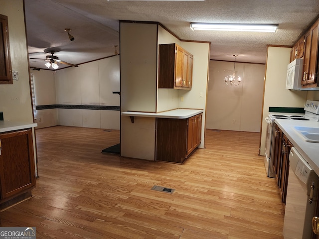 715 Bailey Jester Rd, Griffin, GA 30224 - kitchen featuring white appliances, light wood-type flooring, a ceiling fan, a chandelier, and light countertops