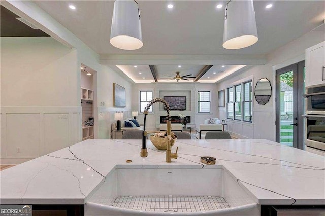 136 Beutell St, Norcross, GA 30071 - kitchen with a sink, a ceiling fan, open floor plan, a decorative wall, and healthy amount of natural light