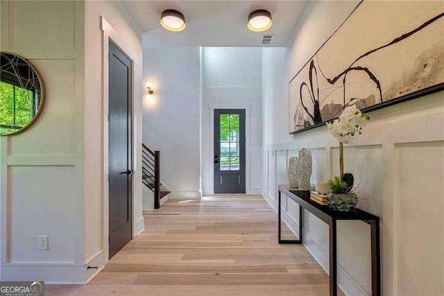 136 Beutell St, Norcross, GA 30071 - foyer entrance featuring stairs, light wood finished floors, and a decorative wall