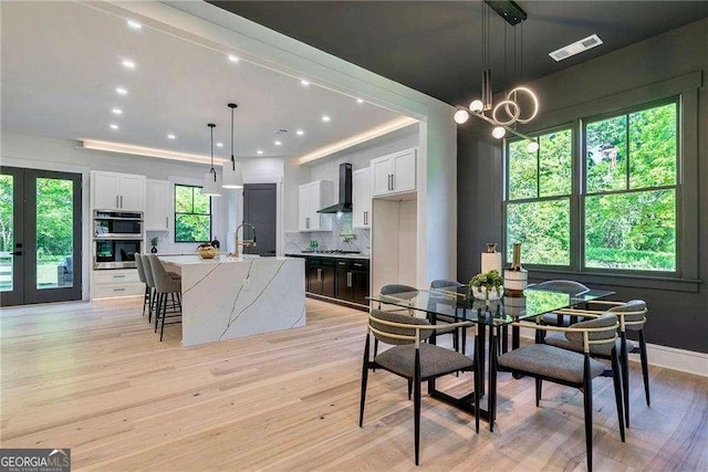 136 Beutell St, Norcross, GA 30071 - dining room featuring light wood-type flooring, recessed lighting, a chandelier, and baseboards