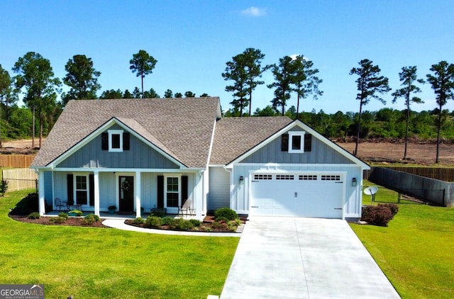 13 Willow Way, Tifton, GA 31793 - view of front of home featuring board and batten siding, an attached garage, driveway, a porch, and a shingled roof