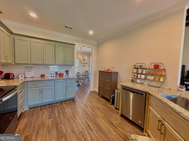13 Willow Way, Tifton, GA 31793 - kitchen featuring stainless steel appliances, crown molding, light wood finished floors, backsplash, and light stone counters