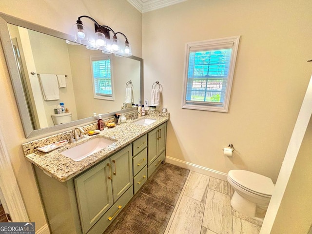 13 Willow Way, Tifton, GA 31793 - bathroom featuring toilet, ornamental molding, double vanity, baseboards, and healthy amount of natural light