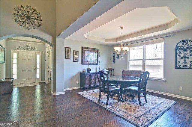514 Creekshire Cir, Canton, GA 30115 - dining room featuring arched walkways, hardwood / wood-style flooring, baseboards, a chandelier, and a raised ceiling