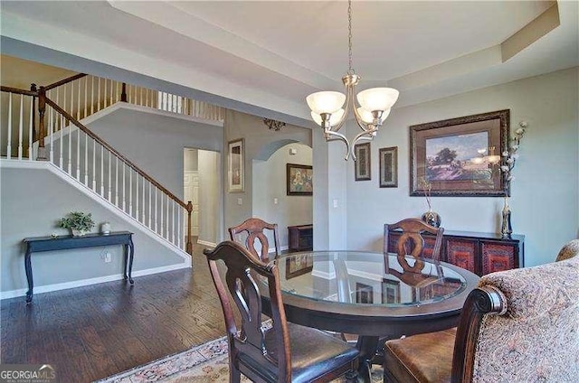 514 Creekshire Cir, Canton, GA 30115 - dining room featuring stairway, a chandelier, wood finished floors, arched walkways, and a raised ceiling