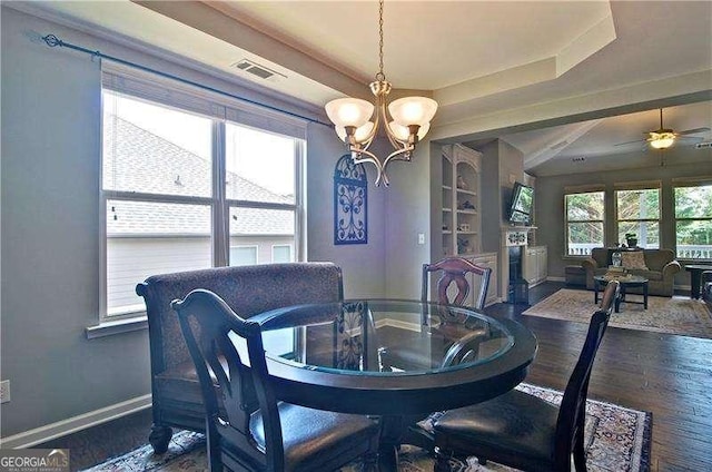 514 Creekshire Cir, Canton, GA 30115 - dining room featuring baseboards, a chandelier, wood finished floors, a raised ceiling, and a fireplace with flush hearth