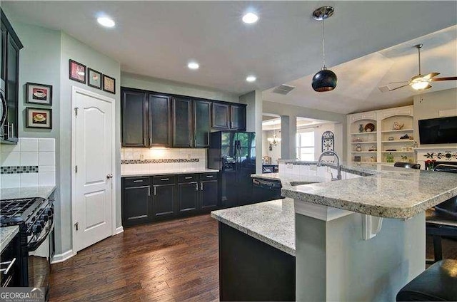 514 Creekshire Cir, Canton, GA 30115 - kitchen with black appliances, a sink, open floor plan, light stone counters, and decorative backsplash