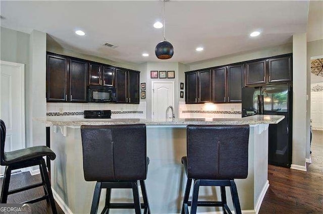 514 Creekshire Cir, Canton, GA 30115 - kitchen with black appliances, decorative backsplash, dark wood-type flooring, a breakfast bar, and recessed lighting