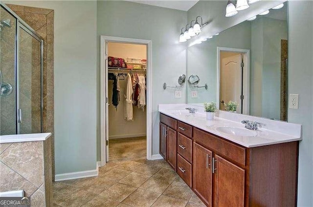 514 Creekshire Cir, Canton, GA 30115 - bathroom with a stall shower, tile patterned flooring, a walk in closet, double vanity, and baseboards