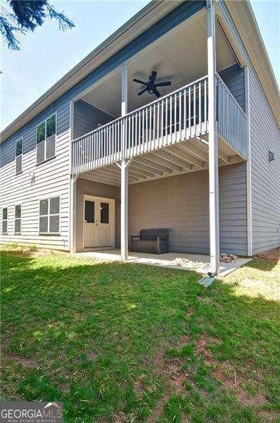 514 Creekshire Cir, Canton, GA 30115 - back of house with ceiling fan, a lawn, and a patio