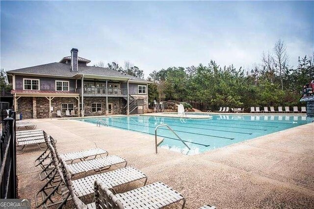514 Creekshire Cir, Canton, GA 30115 - community pool featuring stairway, a patio, and fence