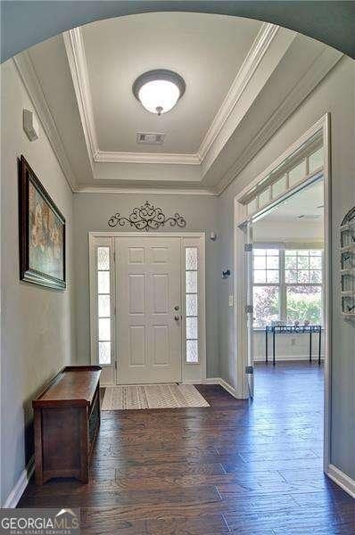514 Creekshire Cir, Canton, GA 30115 - foyer entrance featuring a tray ceiling, ornamental molding, baseboards, and dark wood-type flooring