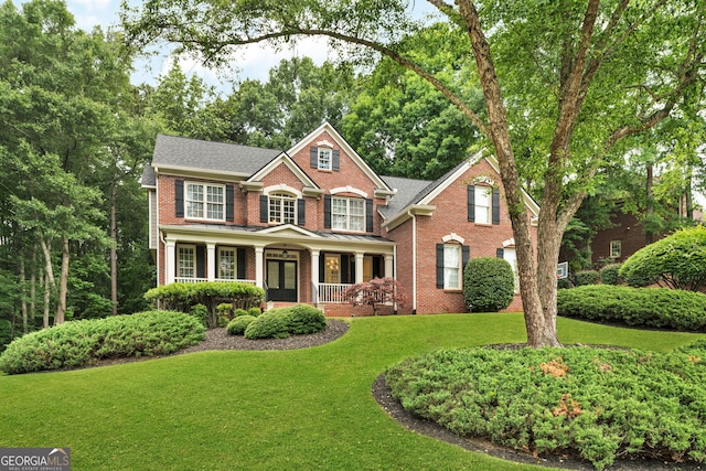 870 River Cliff Ct, Suwanee, GA 30024 - view of front of home featuring brick siding, a porch, a front lawn, and roof with shingles