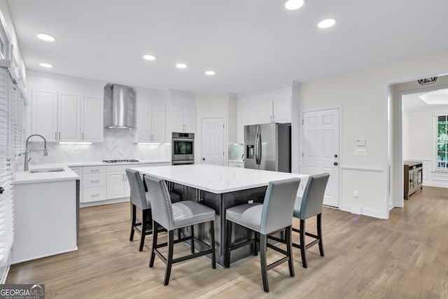 870 River Cliff Ct, Suwanee, GA 30024 - kitchen featuring stainless steel refrigerator with ice dispenser, wall chimney range hood, a sink, gas cooktop, and white cabinets