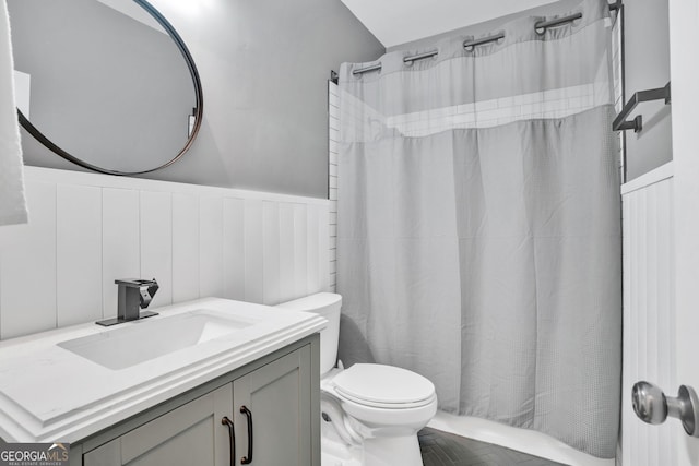 870 River Cliff Ct, Suwanee, GA 30024 - bathroom with a wainscoted wall, toilet, a shower with curtain, vanity, and a decorative wall