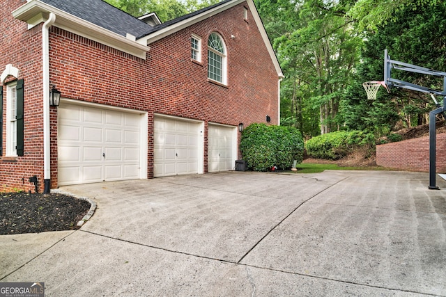 870 River Cliff Ct, Suwanee, GA 30024 - view of property exterior featuring brick siding, driveway, an attached garage, and roof with shingles