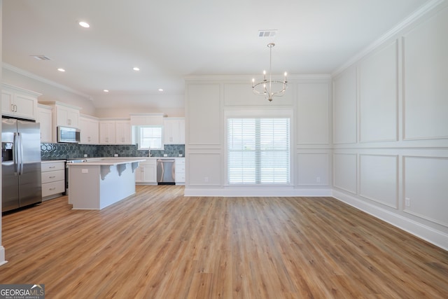3916 Bull Run, Valdosta, GA 31605 - kitchen with stainless steel appliances, a decorative wall, a chandelier, a breakfast bar area, and backsplash