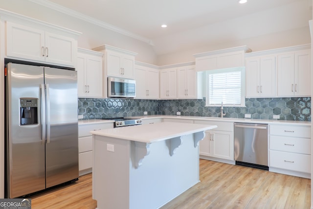 3916 Bull Run, Valdosta, GA 31605 - kitchen featuring appliances with stainless steel finishes, white cabinets, light countertops, light wood-style flooring, and a center island