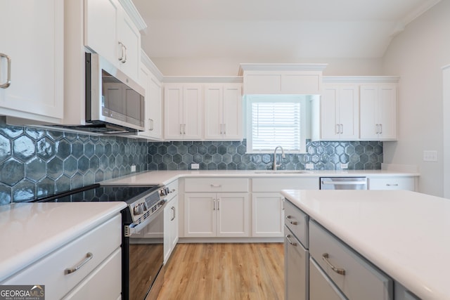 3916 Bull Run, Valdosta, GA 31605 - kitchen featuring stainless steel appliances, a sink, light wood-style flooring, light countertops, and white cabinetry