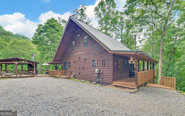view of property exterior with a wooden deck
