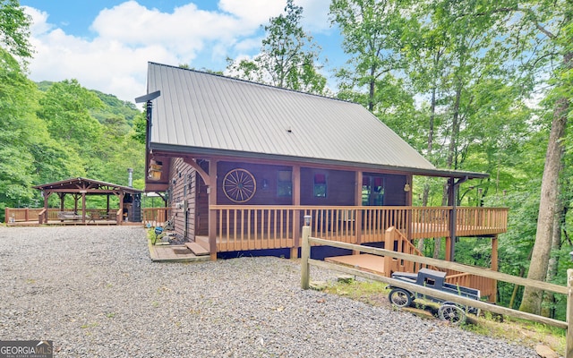 view of front of home featuring metal roof, a deck, and a gazebo