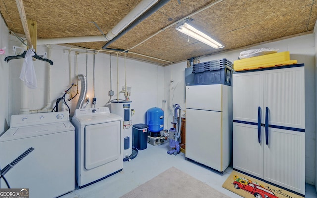 washroom with water heater, separate washer and dryer, and concrete block wall