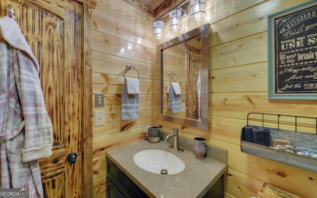 bathroom with wooden walls and vanity