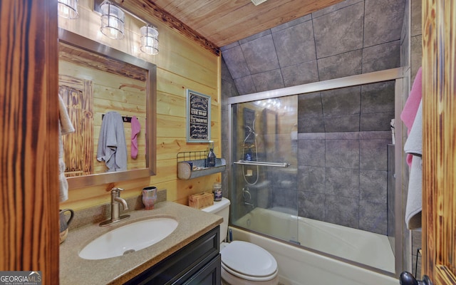 full bathroom featuring wooden ceiling, wood walls, shower / bath combination with glass door, vanity, and toilet