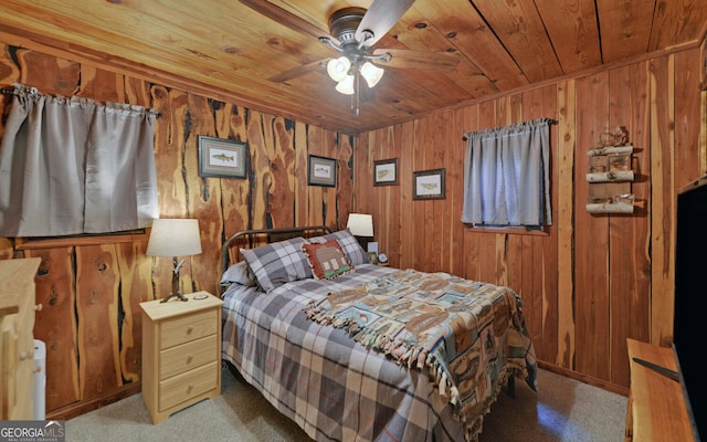 carpeted bedroom with wooden ceiling and wooden walls