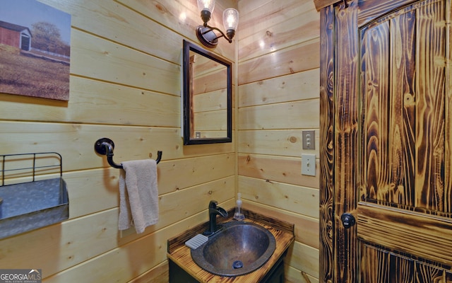 bathroom with a sink and wooden walls