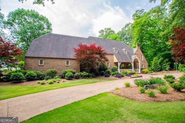 98 Sweetbriar Ln, Carrollton, GA 30117 - view of front of home with a chimney, a front yard, and covered porch