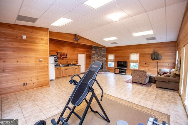 98 Sweetbriar Ln, Carrollton, GA 30117 - exercise room with wooden walls, vaulted ceiling, and light tile patterned floors