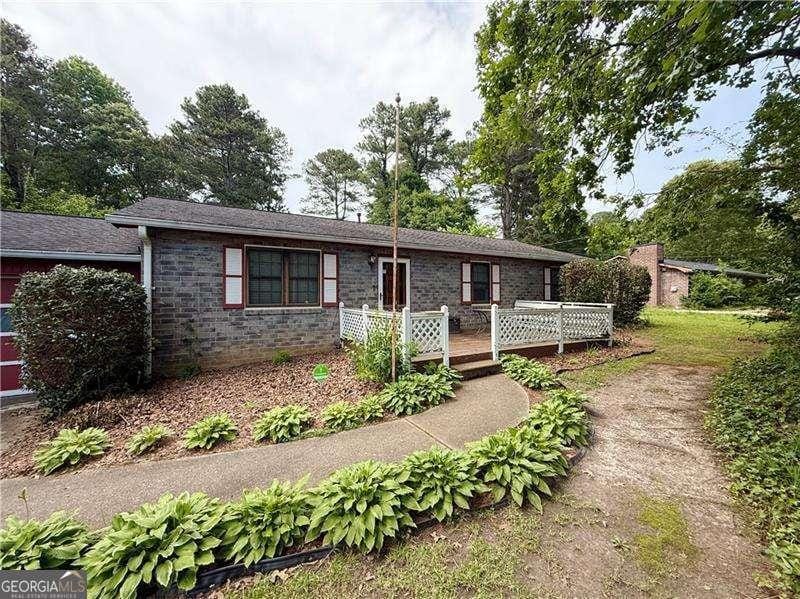 2857 Spanish Oak Dr SW, Lilburn, GA 30047 - ranch-style house featuring a deck and brick siding