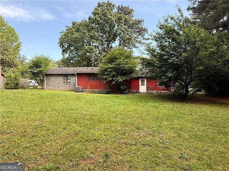 2857 Spanish Oak Dr SW, Lilburn, GA 30047 - view of green lawn featuring central AC unit