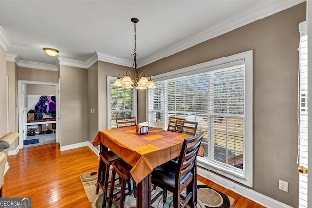 101 Lumby Ln, Stockbridge, GA 30281 - dining room featuring a chandelier, light wood finished floors, baseboards, and crown molding