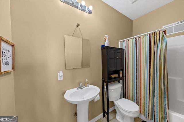 101 Lumby Ln, Stockbridge, GA 30281 - bathroom featuring toilet, shower / bathtub combination with curtain, and a sink