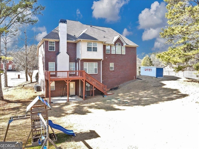 101 Lumby Ln, Stockbridge, GA 30281 - rear view of house featuring stairs, a deck, a chimney, brick siding, and a patio area