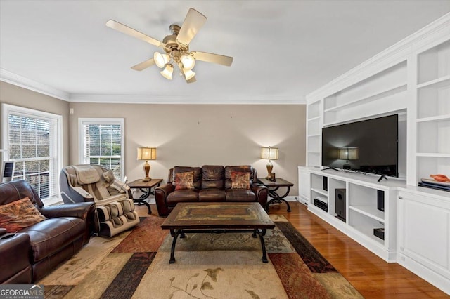 101 Lumby Ln, Stockbridge, GA 30281 - living room with wood finished floors, ornamental molding, built in shelves, ceiling fan, and baseboards