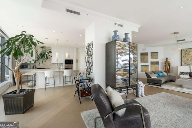 3344 Peachtree Rd NE Unit 3601, Atlanta, GA 30326 - living area with light wood-style floors, recessed lighting, and crown molding
