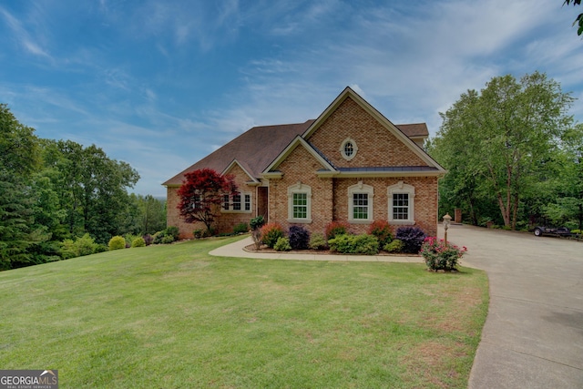 view of front of house with brick siding and a front yard