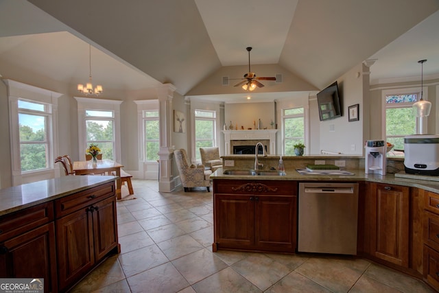 kitchen with dishwasher, a sink, ceiling fan, a tiled fireplace, and light stone countertops
