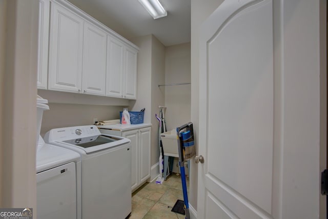 laundry area with cabinet space and independent washer and dryer