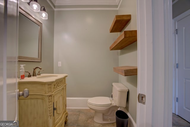 bathroom featuring crown molding, vanity, toilet, and baseboards