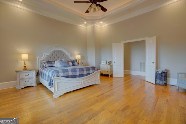 bedroom featuring crown molding, light wood-style flooring, a high ceiling, baseboards, and recessed lighting